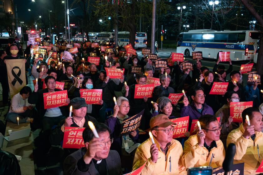 Approximately 100 members of the National Union of Media Workers, the Media Control Prevention Joint Action, the 4.16 Solidarity, the 4.16 Foundation, and journalists from KBS, MBC, YTN, and TBS are chanting slogans at a candlelight rally in front of the KBS main building in Yeouido, calling for the restoration of public broadcasting and the prevention of media control in Seoul, South Korea, on April 3, 2024. (Photo by Chris Jung/NurPhoto via Getty Images)