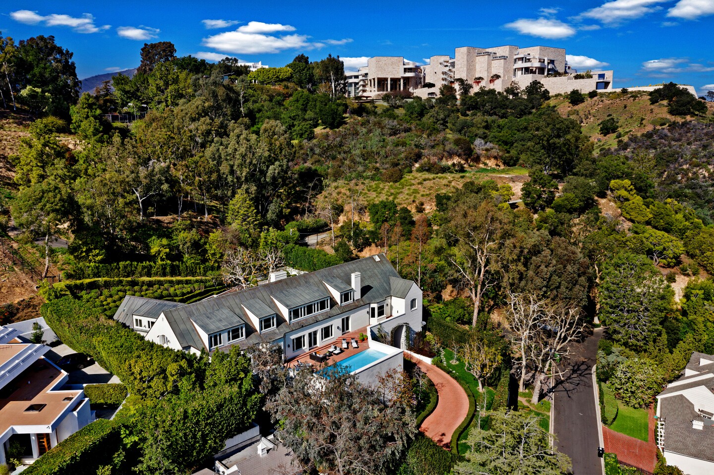 Sited below the Getty in Brentwood, the brick-clad residence was designed to evoke Denmark's traditional farmhouse architecture. Listed for $11.995 million, the Peter Chaote-designed house is reached by a winding drive that passes through a tunnel to reach the front motor court. The roughly two-third-acre property includes a greenhouse and a swimming pool. Expansive terraces center on views of the cityscape. The 7,958-square-foot house has a dual-island kitchen, a gym, four brick fireplaces, five bedrooms and 4.5 bathrooms.
