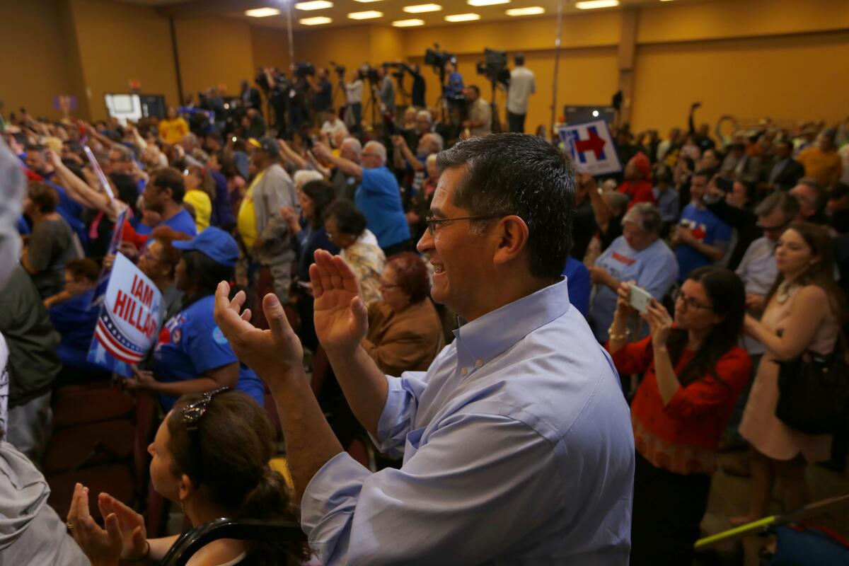 HENDERSON, NV: Xavier Becerra, (D-CA), California's Congressman and Chairman of the House Democratic Caucus, applauds during as Hillary Clinton speaks during a rally at Painter's Hall in Henderson, NV. He is meeting with political leaders, journalists, and members of the public at the rally. (Francine Orr/ Los Angeles Times)