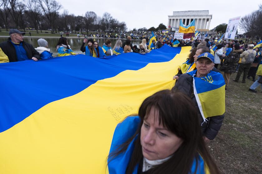 Ukrainians and their supporters carry a huge Ukrainian flag during a rally at the National Mall near the Lincoln Memorial in Washington, marking two years since Russia's full scale war and invasion of Ukraine, Saturday, Feb. 24, 2024. (AP Photo/Manuel Balce Ceneta)