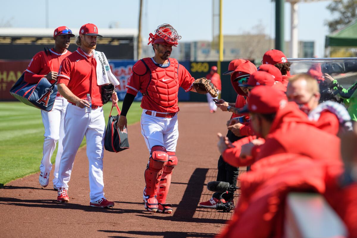 Angels catcher Kurt Suzuki greets his teammates before a spring training game.