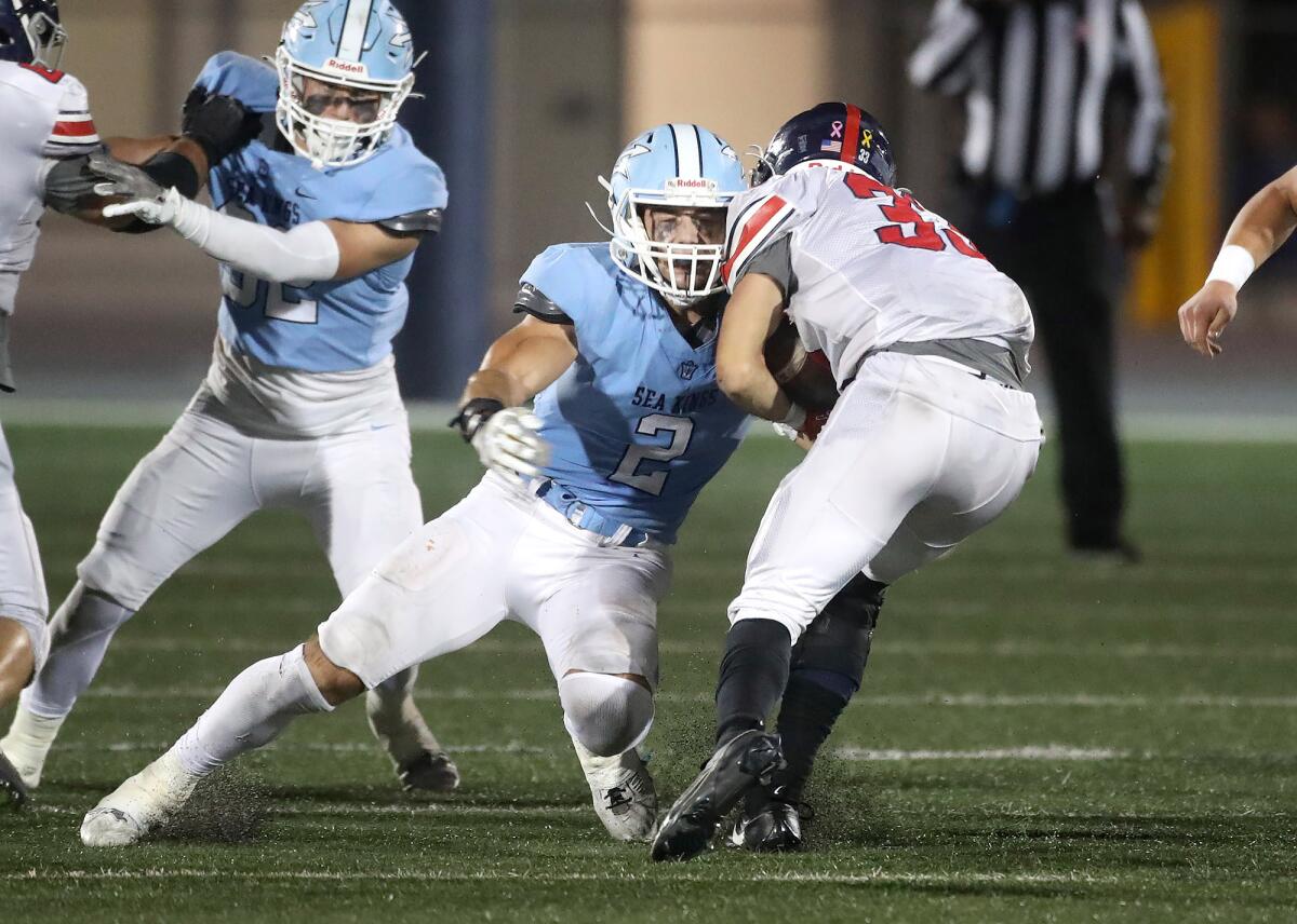 CdM linebacker Christian Brooks (2) meets Jason Escovar at the line of scrimmage during Friday's win over Yorba Linda.