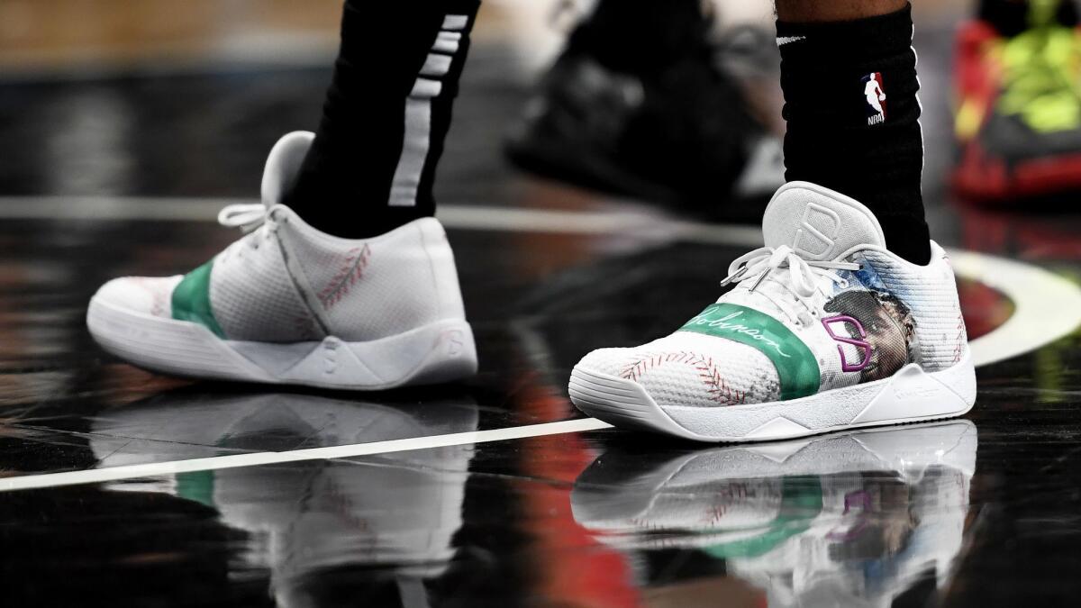 Spencer Dinwiddie wears sneakers honoring former Brooklyn Dodger Jackie Robinson during the first quarter of a game at Barclays Center in New York last month.