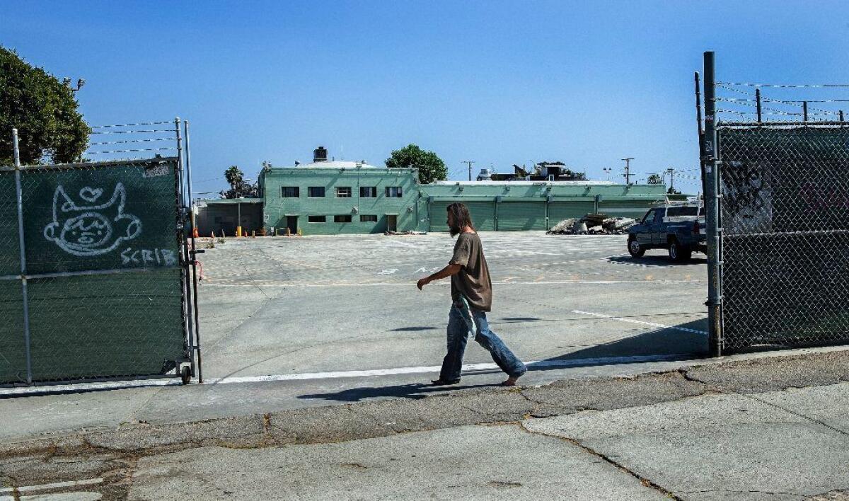 A pedestrian walks past the entrance to a former MTA facility on Sunset Avenue in Venice, a proposed location for a homeless shelter that has been strongly opposed by some nearby residents.