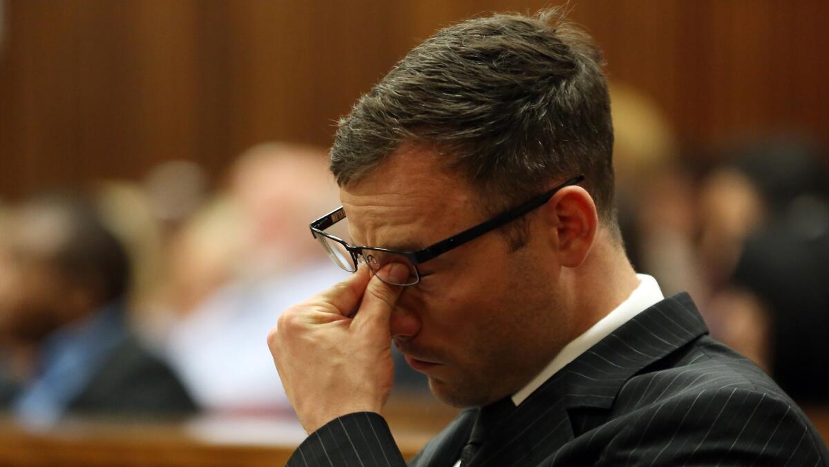 Oscar Pistorius rubs his eyes as he sits in court in Pretoria, South Africa, on Oct. 14.