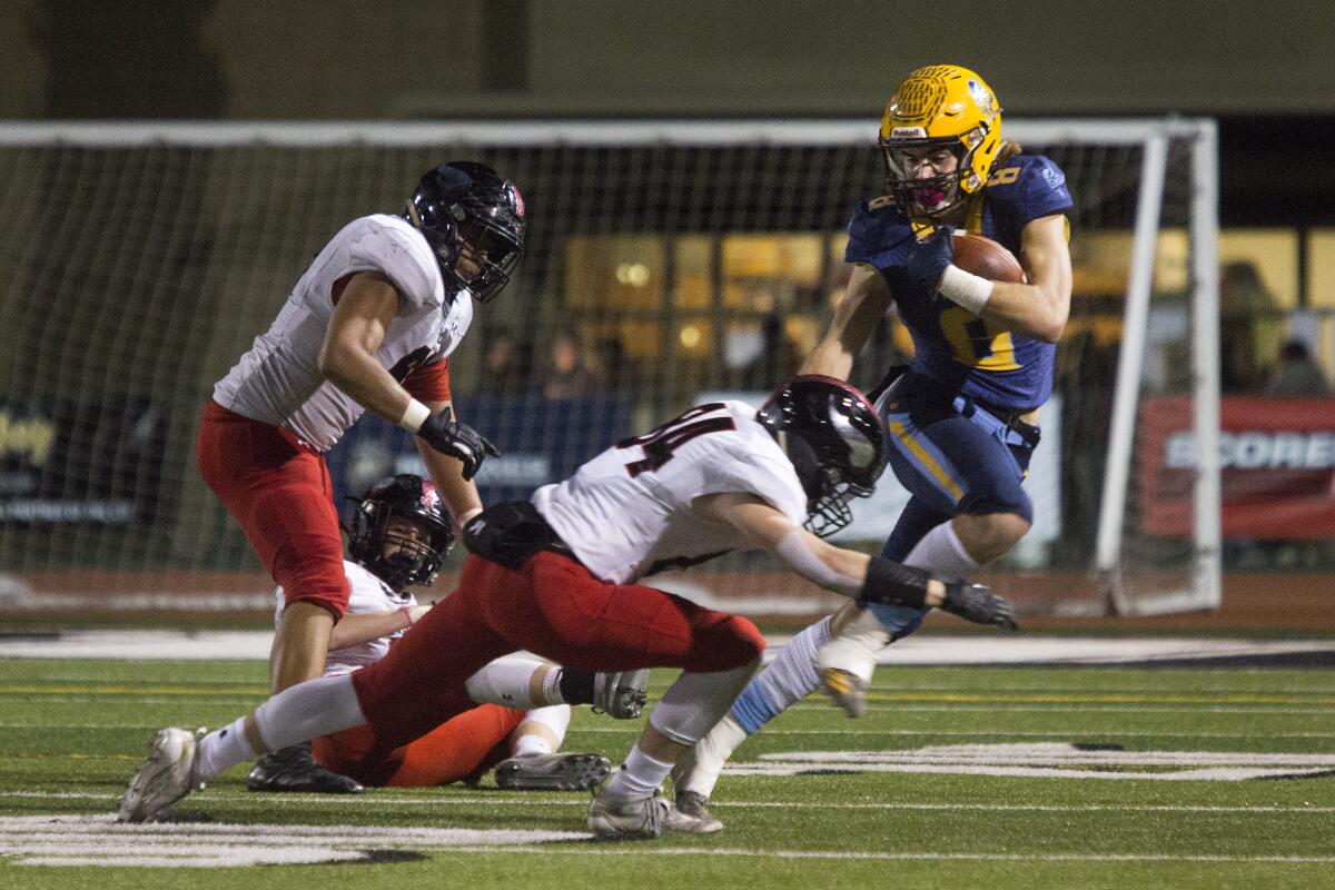 Marina junior Dane Brenton, shown fighting for yardage against La Jolla on Dec. 7, 2019, helped the Vikings win their first league title since 1986.