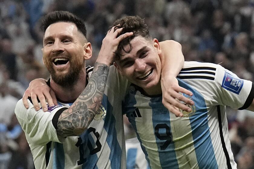 Argentina's Lionel Messi, left, and Argentina's Julian Alvarez celebrate 