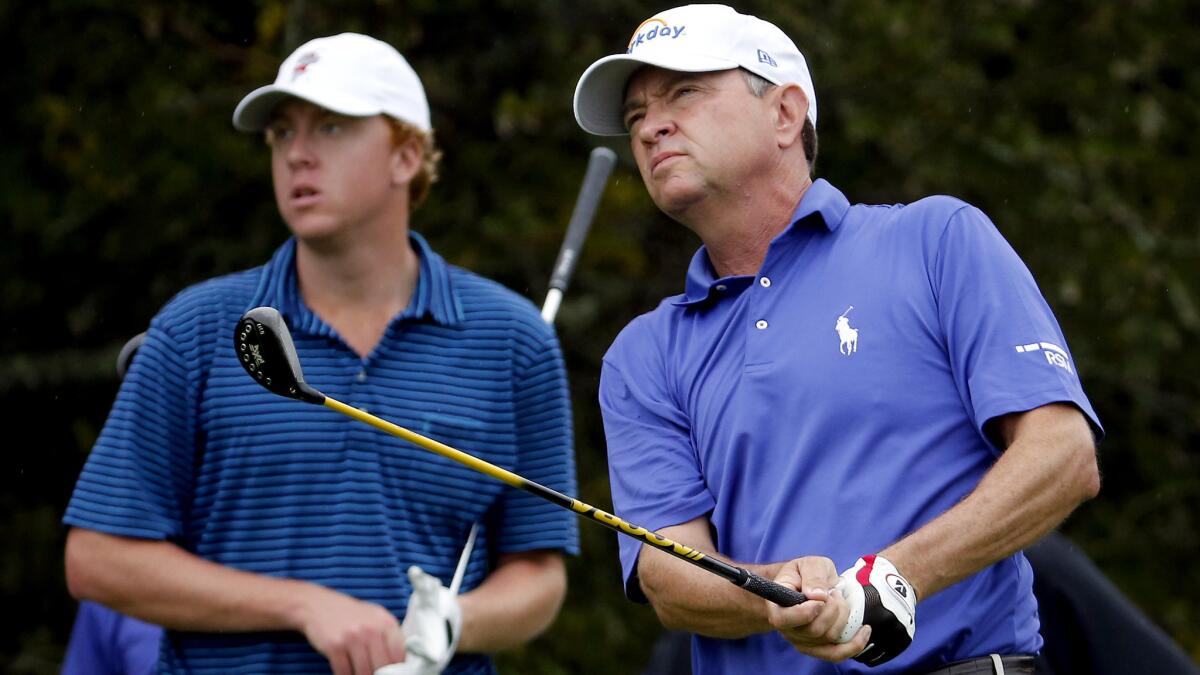 Davis Love III, and son Davis Love IV watch his tee shot at No. 2 on Thursday.