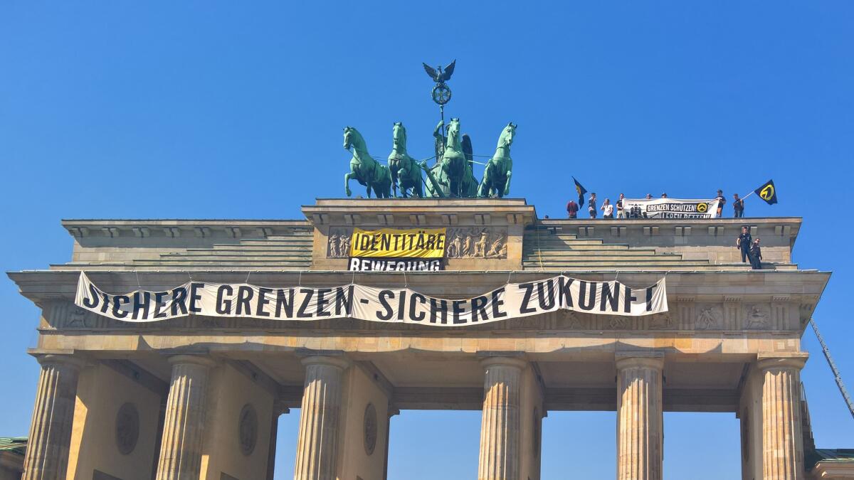 Anti-refugee activists staged a protest Aug. 27 atop the Brandenburg Gate in Berlin, and hung a banner reading: "Secure the Borders - Secure the Future."