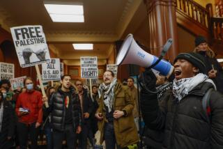 Cambridge, MA - January 29: Kojo Acheampong, a Harvard student and member of AFRO (African and African American Resistance Organization), speaks to Pro-Palestine supporters in the lobby of Cambridge City Hall before their scheduled meeting. Because of the planned protest the City Council opted to have their meeting virtually. (Photo by Matthew J. Lee/The Boston Globe via Getty Images)