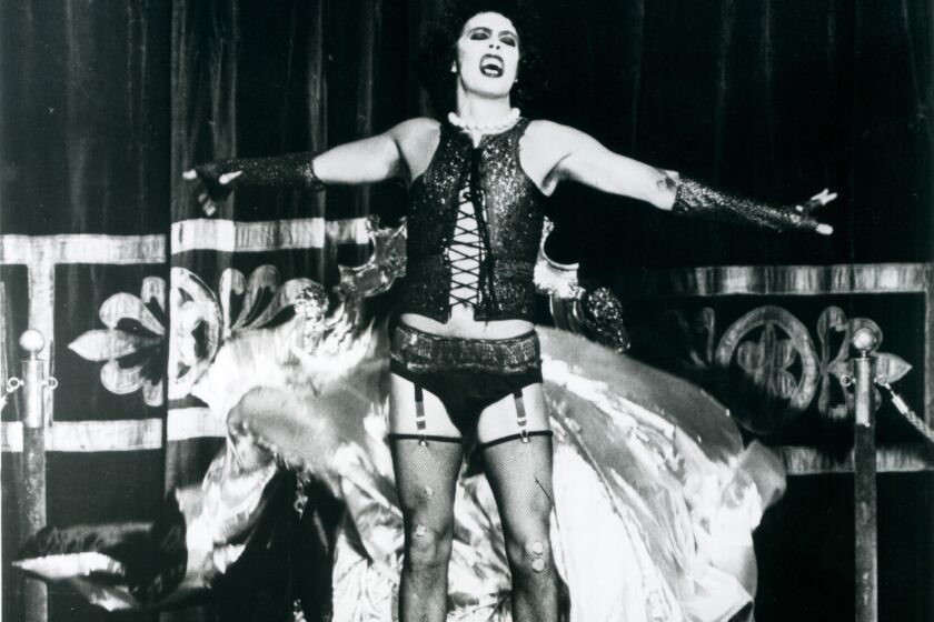 Frank N Furter (Tim Curry), an alien transvestite, shows off his full stage ensemble for "Rocky Horror."