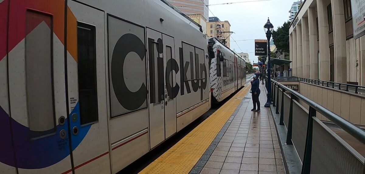 A ClickUp advertisement is seen on the San Diego Trolley.