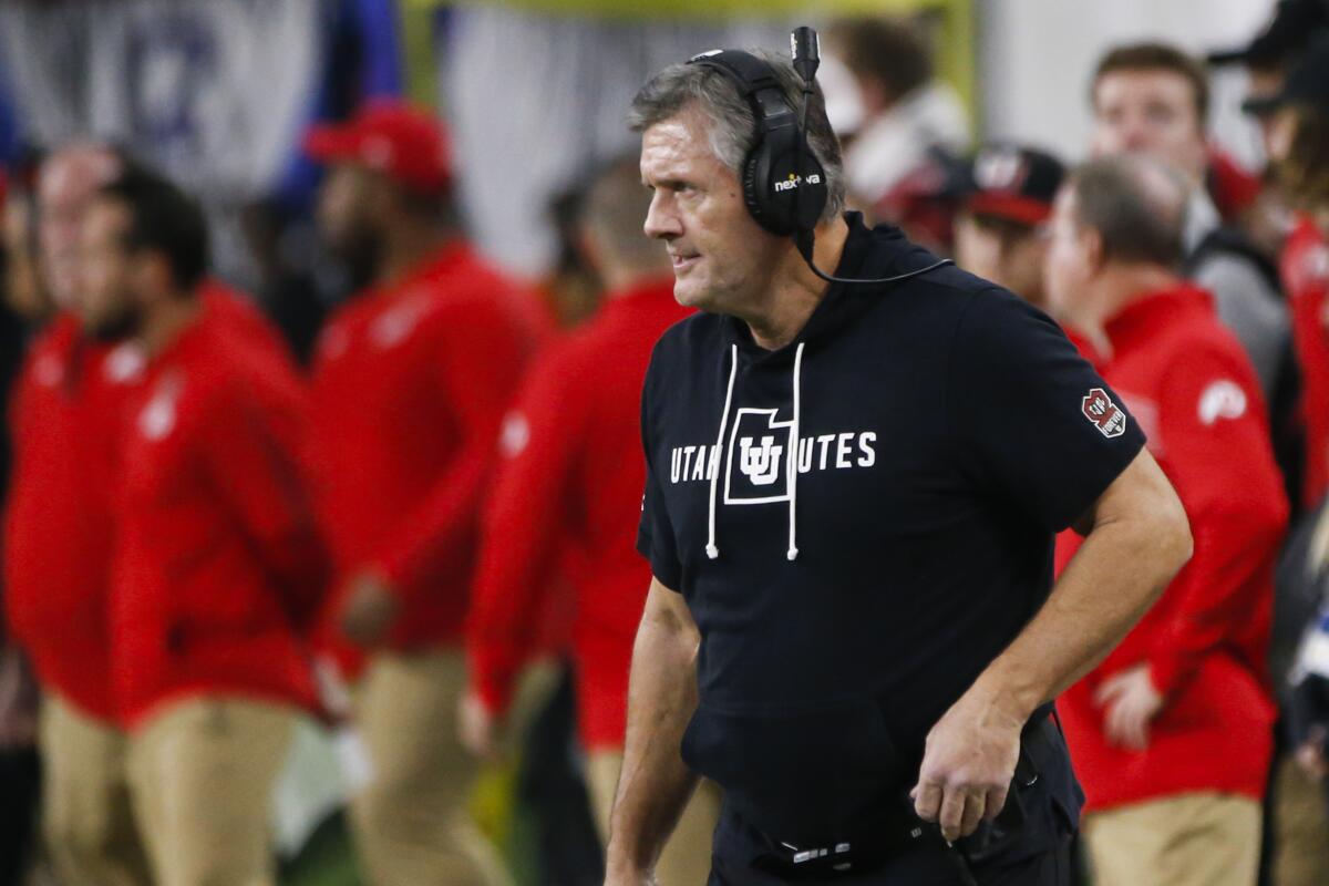 Utah coach Kyle Whittingham stands on the sideline during a game.