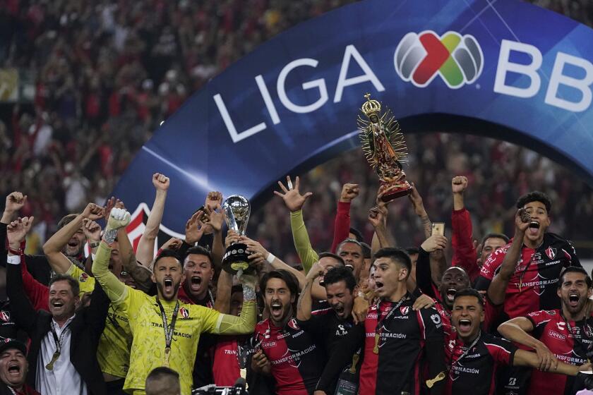 Mexico's Atlas players lift the trophy after winning the Mexican soccer league final match against Mexico's Leon in Guadalajara, Sunday, Dec. 12, 2021. (AP Photo/Eduardo Verdugo)