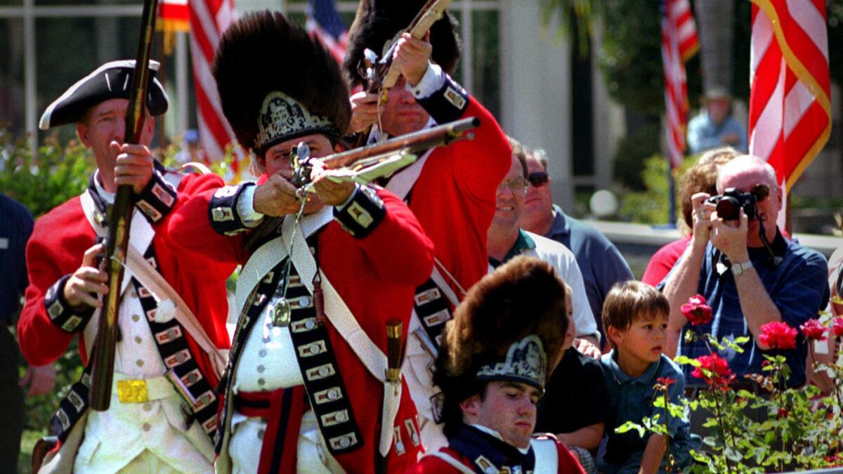 Actors playing British soldiers participate in a Revolutionary War reenactment at the Nixon Library in Yorba Linda.
