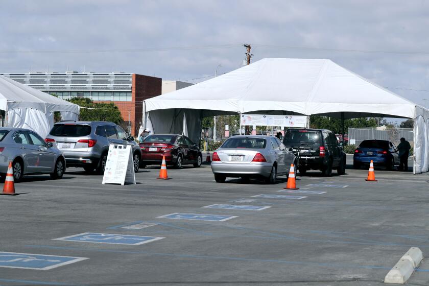 Vehicles line up at the Covid-19 testing super-site at the Orange County Fair and Event Center in Costa Mesa on Friday, Jan, 22, 2021.