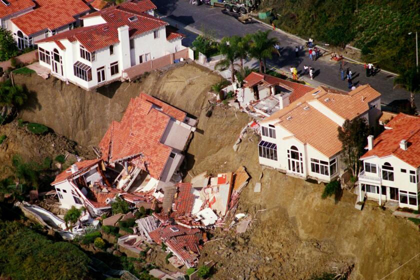 1998 aerial view of two homes on Via Estoril in Laguna Niguel fell when a rain soak hillside collapsed 