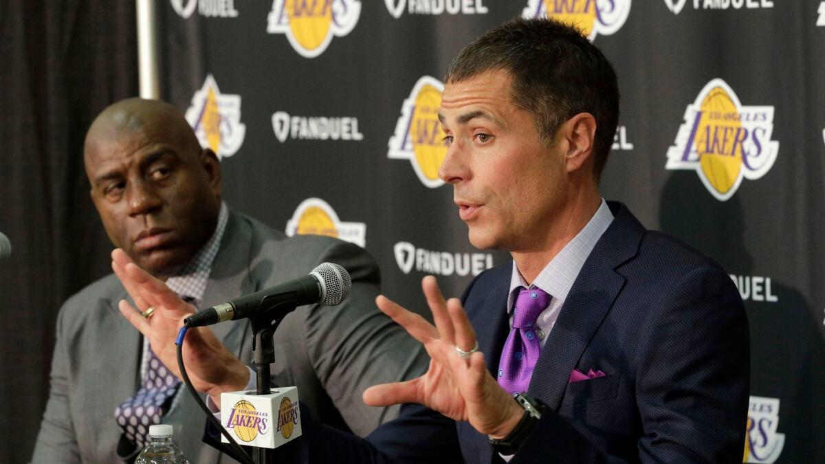 Lakers President of Basketball Operations Magic Johnson, left, listens as General Manager Rob Pelinka talks during a news conference on March 10.