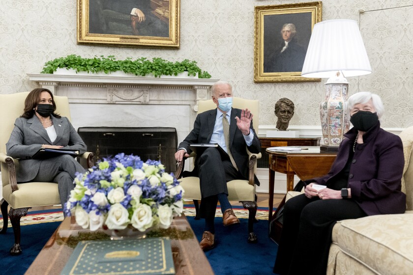 President Biden sitting by the Oval Office fireplace with Vice President Kamala Harris and Treasury Secretary Janet Yellen