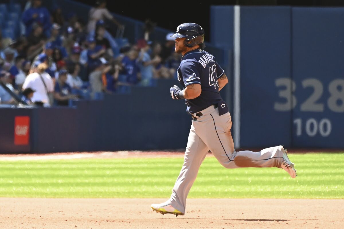 Tampa Bay Rays' Harold Ramirez runs the bases after hitting a two-run home run, also scoring Wander Franco, in the fifth inning of a baseball game against the Toronto Blue Jays in Toronto, Sunday, July 3, 2022. (Jon Blacker/The Canadian Press via AP)