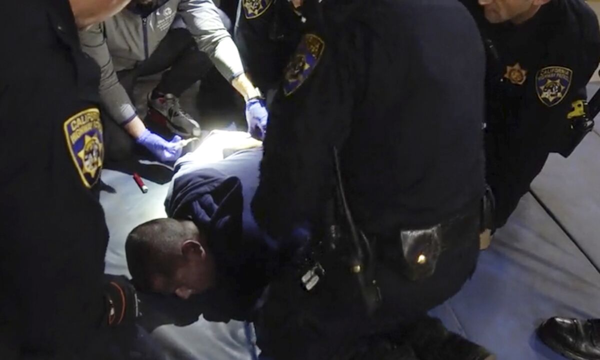 In this image taken from a nearly 18-minute video taken by a California Highway Patrol sergeant, Edward Bronstein, 38, is being taken into custody by CHP officers on March 31, 2020, following a traffic stop in Los Angeles. Bronstein died nearly two years ago as he screamed "I can't breathe" while multiple officers restrained him as they tried to take a blood sample, according to records and a video. The video was released Tuesday, March 15, 2022, after a judge's order to make it public. Bronstein's family has filed a federal lawsuit against the officers, alleging excessive force and a violation of civil rights. (California Highway Patrol via AP)