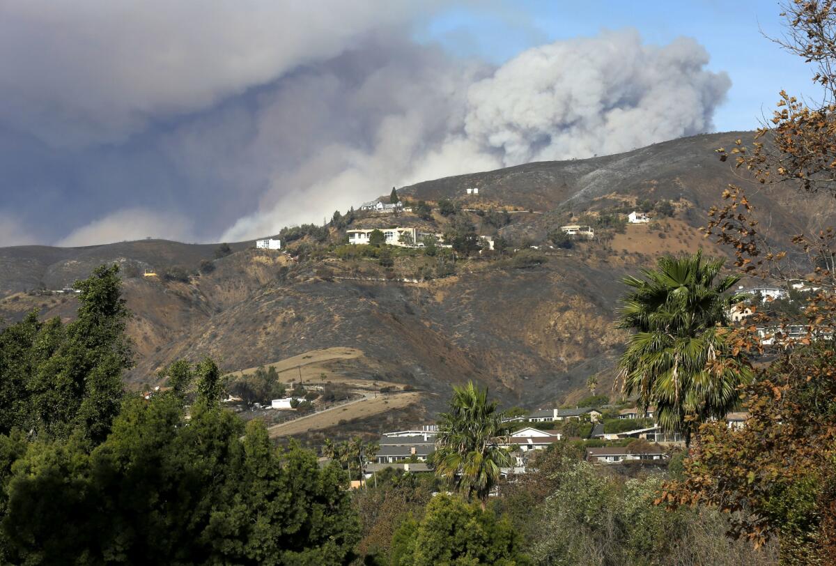 Smoke billows over western Malibu from a flare-up of the Woolsey fire in Lake Sherwood on Tuesday.