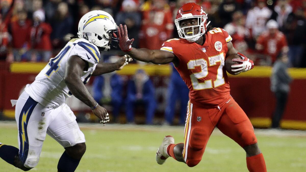 Kansas City Chiefs running back Kareem Hunt (27) stiff arms Chargers linebacker Melvin Ingram (54) during a game last season. The two teams will meet in Week 1.