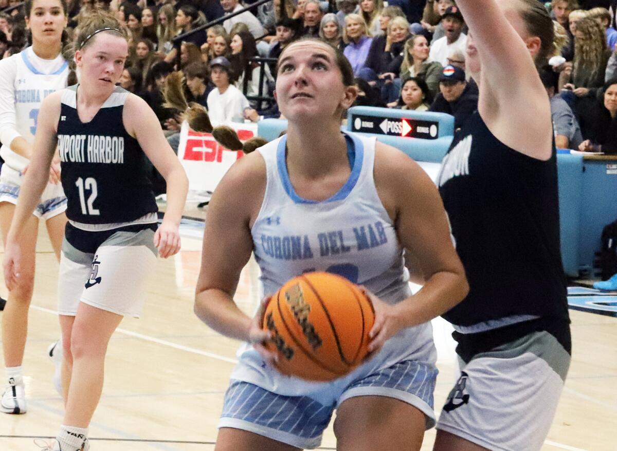 Corona del Mar's Kayly Honig (10) drives to the basket against Newport Harbor in the Battle of the Bay on Saturday.