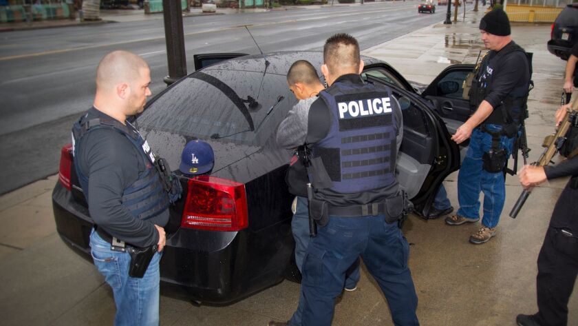 U.S. Immigration and Customs Enforcement agents arrest a man as part of an immigration sweep in Los Angeles two weeks ago.
