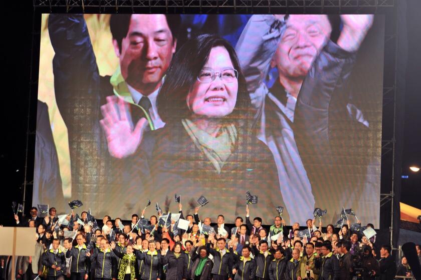 Taiwan President-elect Tsai Ing-wen appears on a screen as she celebrates her victory alongside party officials in Taipei, Taiwan.
