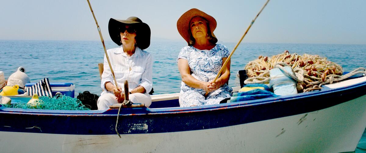 Two women in floppy hats go fishing.