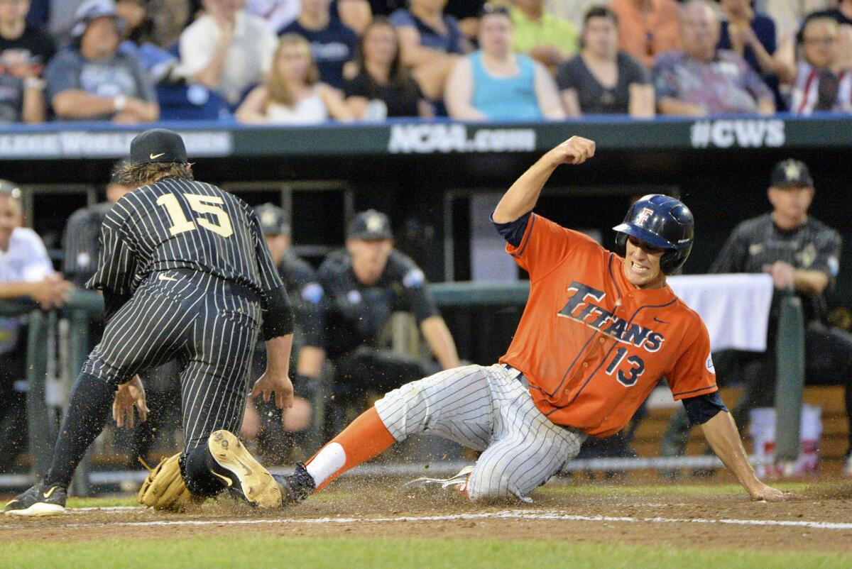 Cal State Fullerton's Timmy Richards scores on a wild pitch as Vanderbilt pitcher Carson Fulmer covers the plate in the fifth inning Sunday.