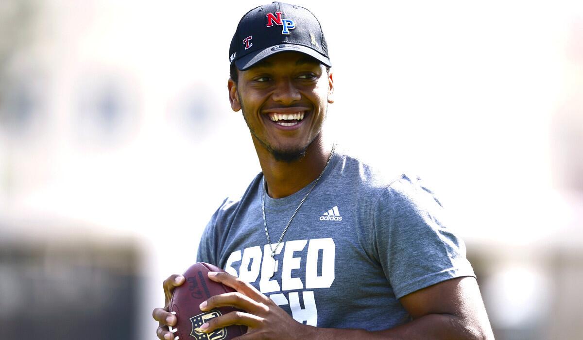 Quarterback Brett Hundley smiles while he warms up during UCLA's pro day on Tuesday.