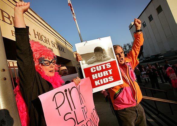 Cathy Brooks, left, and Dan Hyke join other teachers and school support staff in front of Alhambra High School on "Pink Friday" to protest potential layoffs.