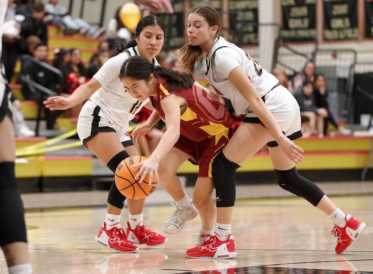 Ocean View's Laney Bae (0) drives through two defenders during a Golden West League game against Segerstrom on Wednesday.