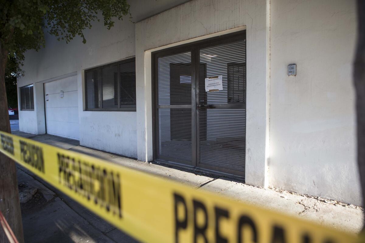 Police tape surrounds the entrance of the home where marines engaged in a gun battle during the search for Mexican drug lord Joaquin “El Chapo” Guzman, in Los Mochis, Mexico, Sunday, Jan. 10, 2016.