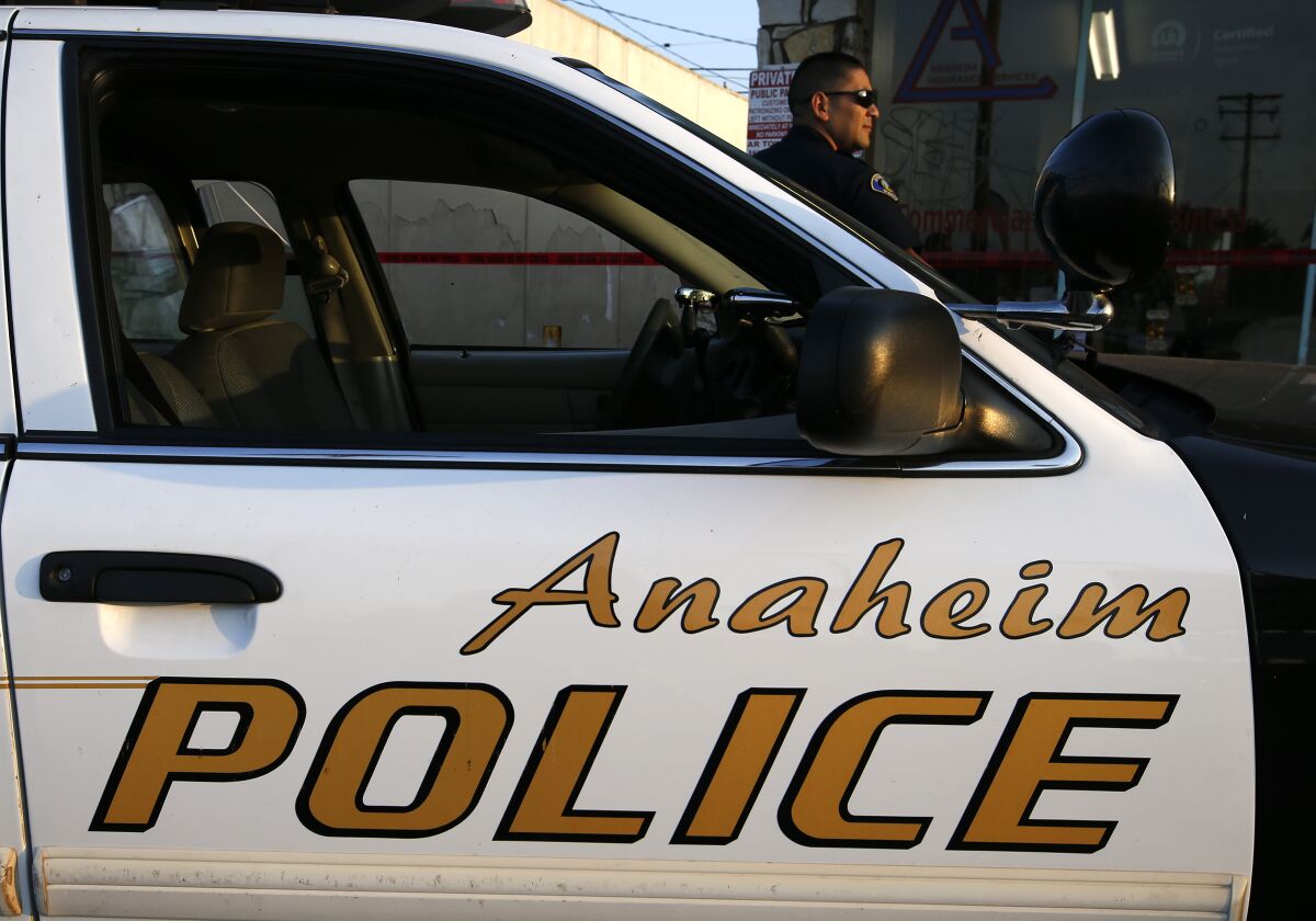 An Anaheim officer and police car