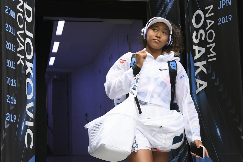 Naomi Osaka walks into Margaret Court Arena for a match at the 2020 Australian Open.