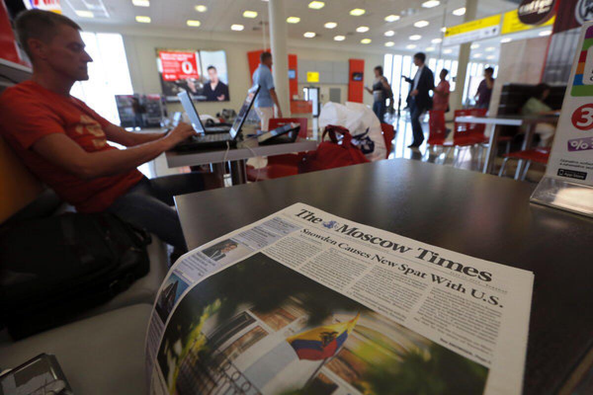 Transit passengers and journalists sit at a cafe in Moscow's Sheremetyevo Airport.