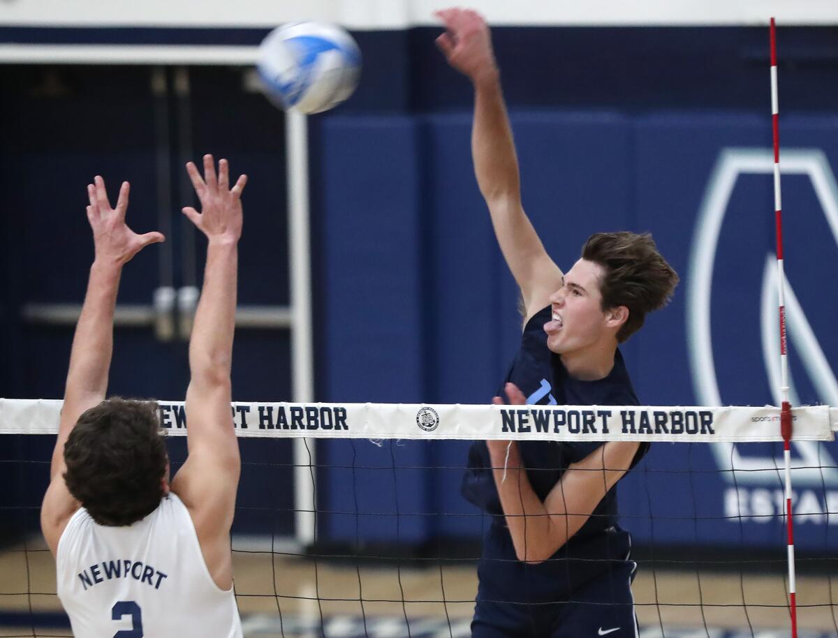 Sterling Foley (11) puts a kill away during the Battle of the Bay boys' volleyball match.