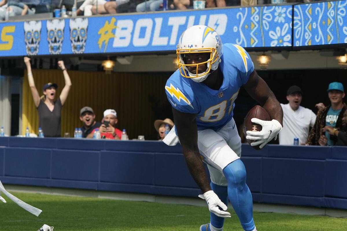 Los Angeles Chargers wide receiver Mike Williams, right, runs after catching a touchdown.