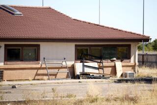 A sign covers the broken back window of the Return to Nature Funeral Home in Penrose, Colo., Monday, Oct. 16, 2023. The remains of at least 189 decaying bodies were found and removed from the Colorado funeral home, up from about 115 reported when the bodies were discovered two weeks ago, officials said Tuesday, Oct. 17. (AP Photo/David Zalubowski)