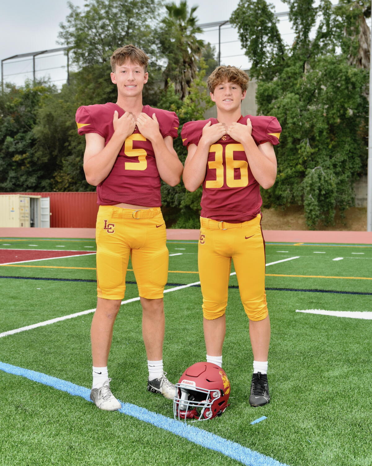 Quarterback Joe Bell (left) and his sophomore brother, Jake, who is a linebacker, pose for a photo in their football uniforms