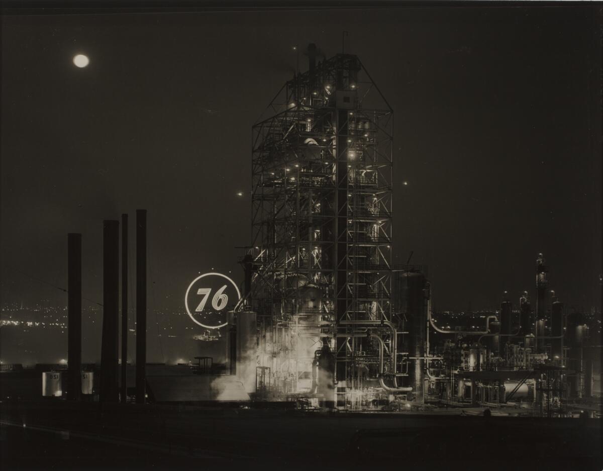 A vintage black and white image shows the Union 76 refinery at night with a bright "76" logo in lights.