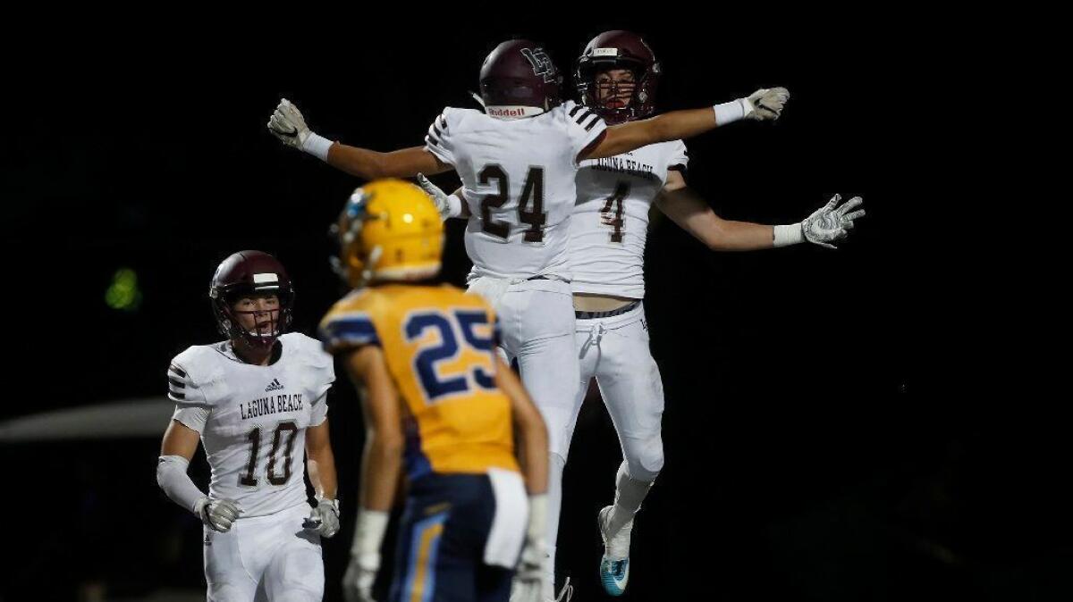 Laguna Beach High receivers Sean Nolan (4) and Kai Ball (24), shown celebrating a touchdown against Marina on Sept. 28, will try to help the Breakers extend their winning streak to five games on Friday.