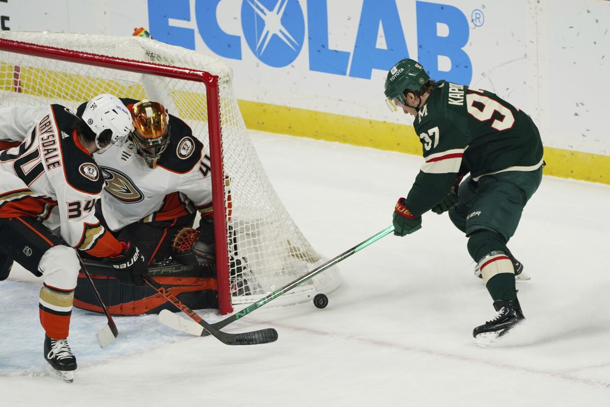 Jamie Drysdale breaks up a wraparound shot attempt by Minnesota forward Kirill Kaprizov on goaltender Anthony Stolarz.