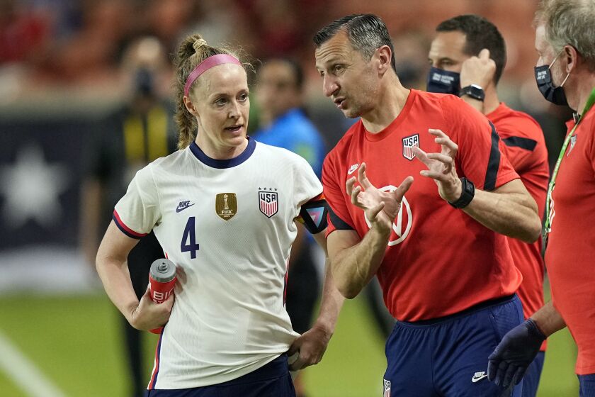 United States women's soccer team coach Vlatko Andonovski, right, talks with Becky Sauerbrunn (4) during the second half of an international friendly soccer match against Portugal Thursday, June 10, 2021, in Houston. (AP Photo/David J. Phillip)