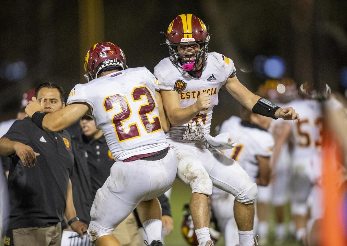 Estancia's August Stanton, left, celebrates with Noah Aires after Stanton scores a touchdown against Loara.