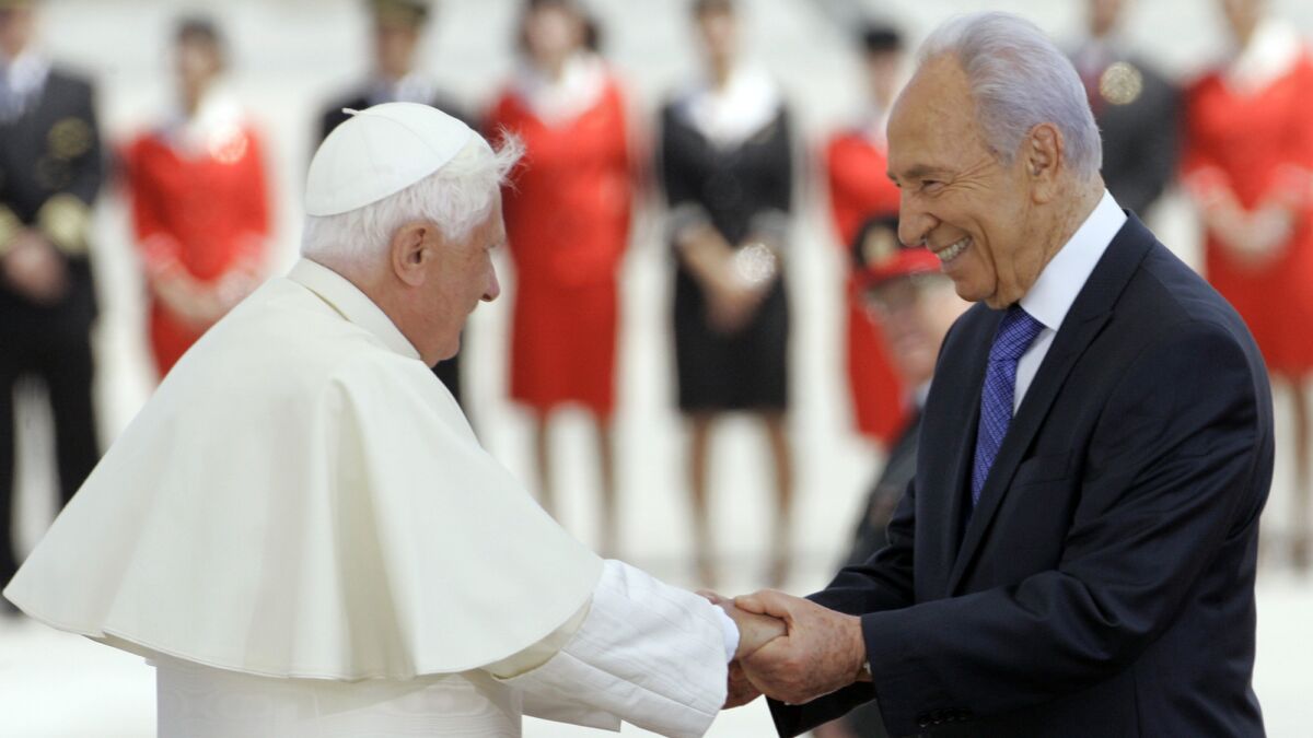 Peres, then Israeli president, welcomes Pope Benedict XVI to Israel on May 11, 2009.