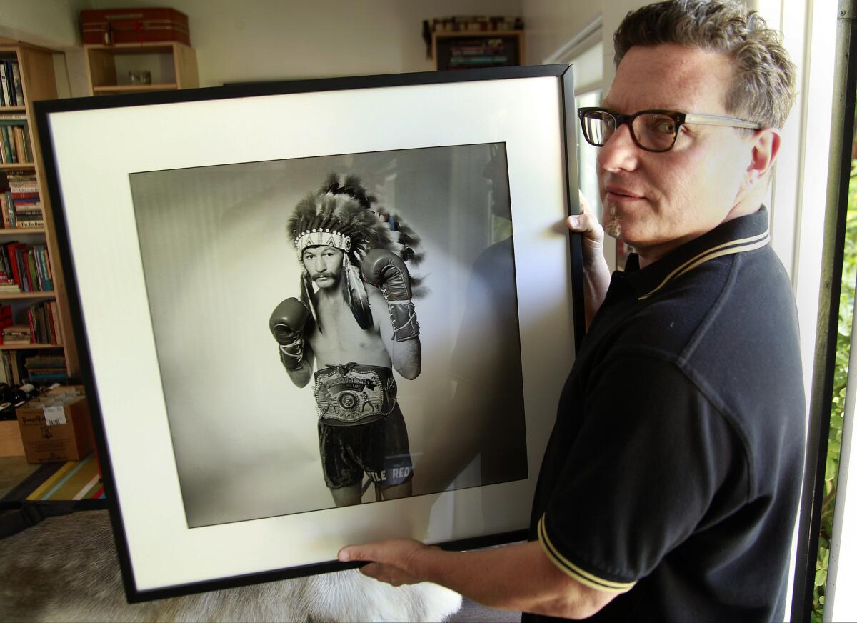 Steve DeBro has collected a mass of memorabilia while making the forthcoming documentary "18th & Grand" about Los Angeles' Olympic Auditorium. Here he holds a photo of boxer Danny Lopez.